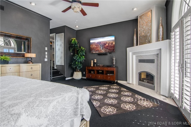 bedroom featuring multiple windows and ceiling fan