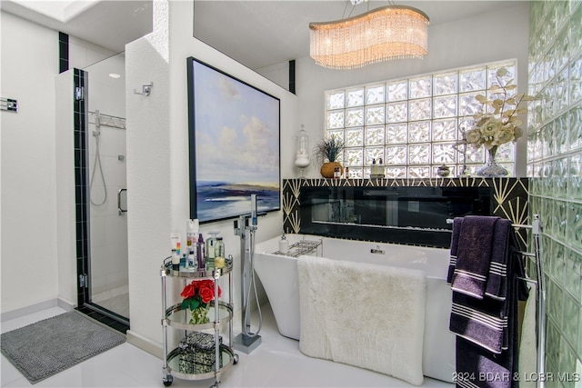 bathroom featuring tile patterned flooring, an inviting chandelier, and plus walk in shower