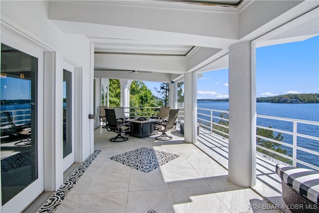 sunroom / solarium featuring a water view and a wealth of natural light