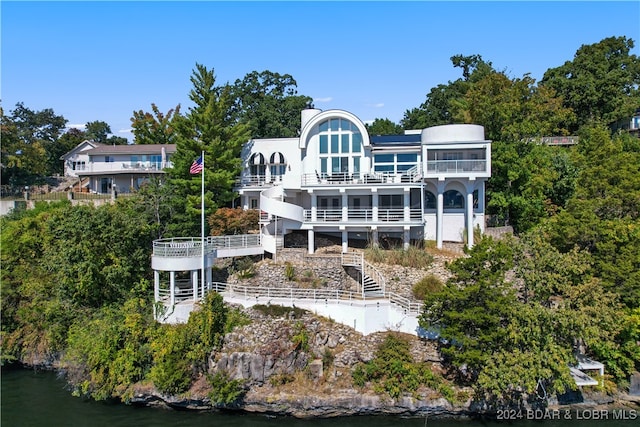 back of property featuring a water view