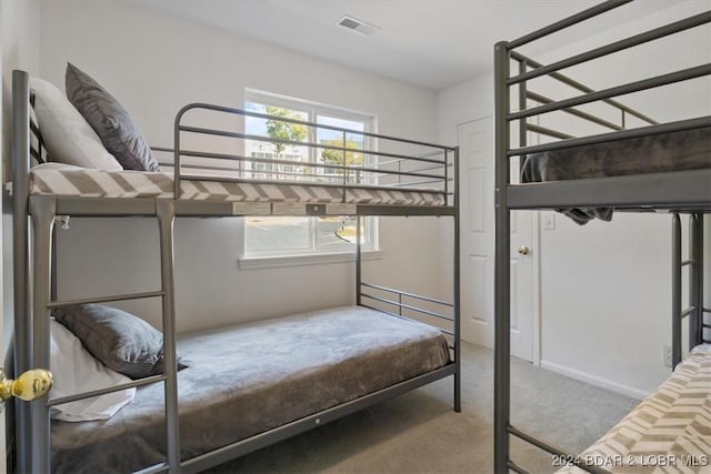 carpeted bedroom with multiple windows and visible vents