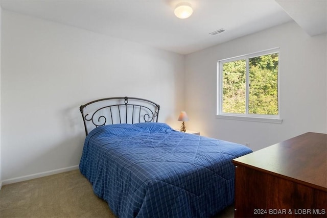 carpeted bedroom with visible vents and baseboards