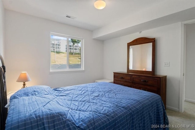 carpeted bedroom featuring baseboards and visible vents