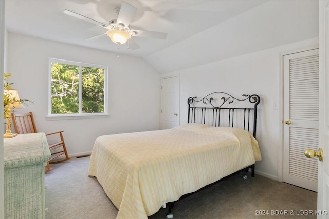 bedroom with baseboards, vaulted ceiling, a ceiling fan, and light colored carpet