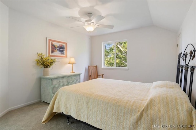 carpeted bedroom featuring vaulted ceiling, baseboards, and ceiling fan