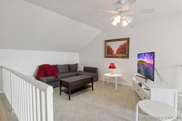 living area with a ceiling fan, light carpet, vaulted ceiling, and baseboards