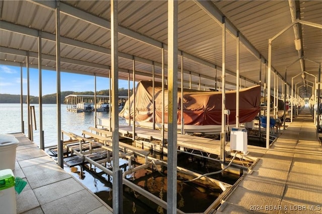 dock area with a water view and boat lift