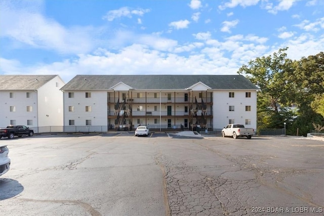 view of property with uncovered parking