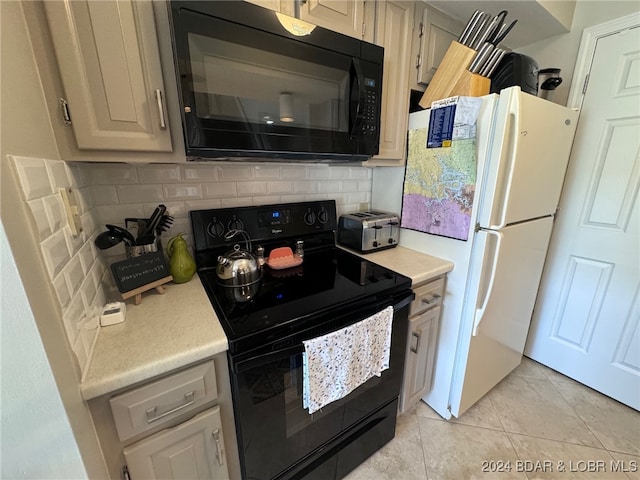 kitchen with black appliances, light tile patterned floors, and tasteful backsplash