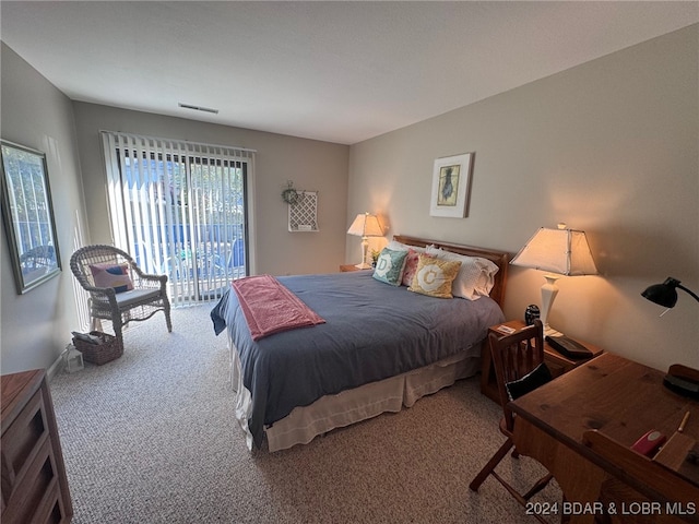 bedroom with access to outside and carpet flooring