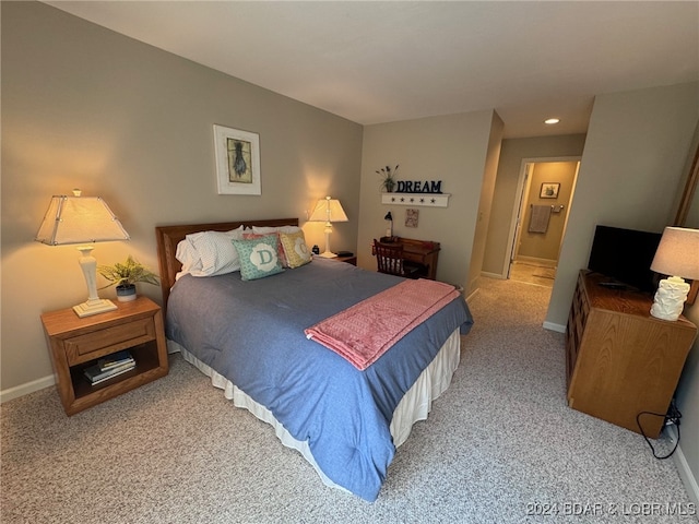 carpeted bedroom with connected bathroom