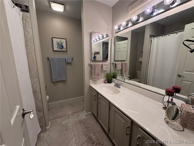 bathroom with tile patterned floors, vanity, and toilet