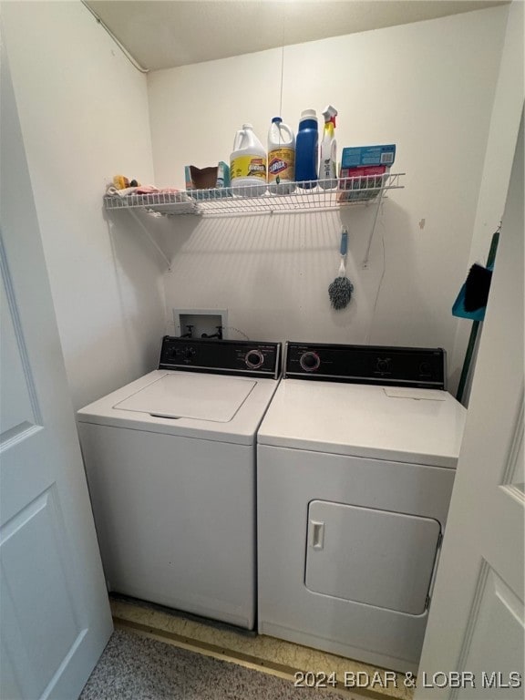 clothes washing area with washer and dryer