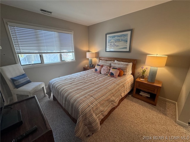 bedroom featuring light carpet