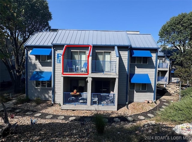 back of property with a balcony