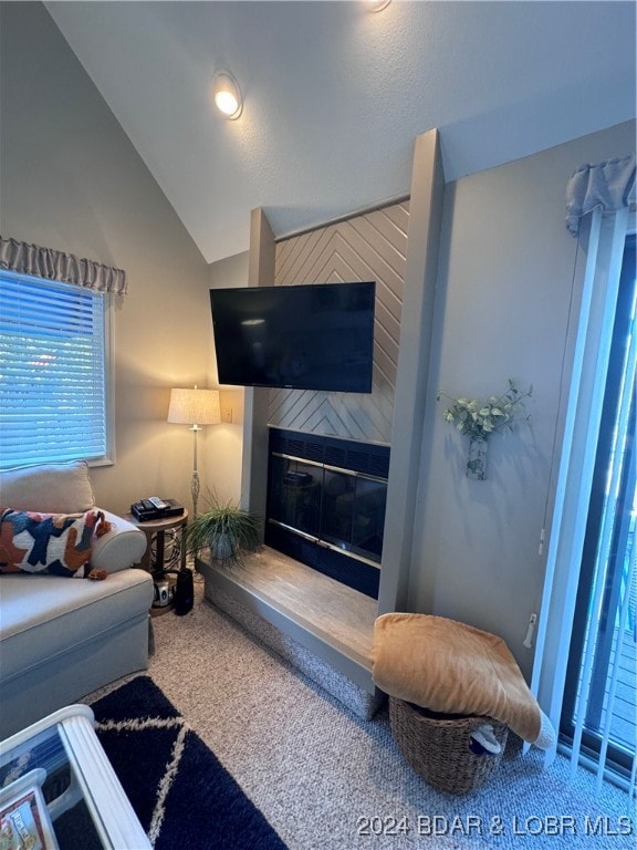 carpeted living room featuring lofted ceiling