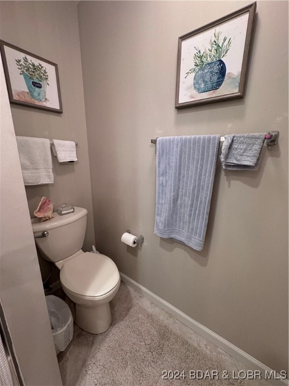 bathroom with tile patterned floors and toilet