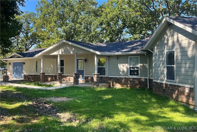 view of front of property with covered porch, a front yard, and a garage