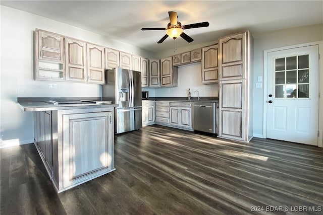 kitchen with ceiling fan, dark wood-type flooring, stainless steel appliances, and sink