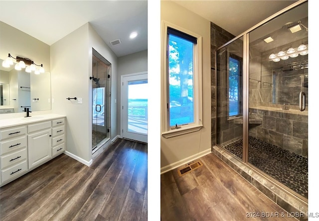 bathroom featuring hardwood / wood-style floors, vanity, and a shower with door