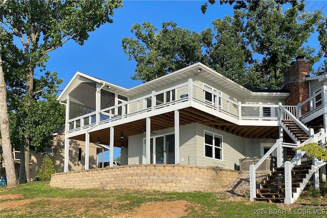 back of house with a sunroom