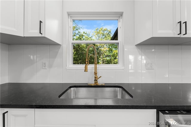 kitchen with a healthy amount of sunlight, sink, and white cabinetry