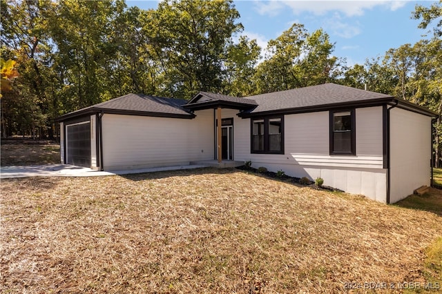 view of front of house with a garage and a front lawn