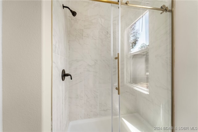 bathroom with a shower with shower door