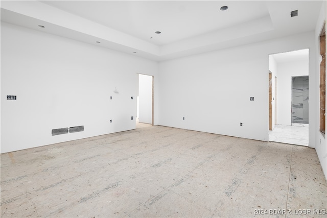 spare room with a tray ceiling