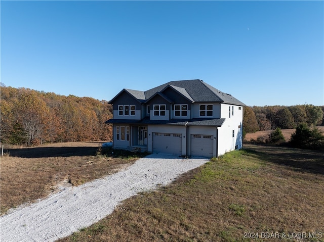 view of front property featuring a front lawn and a garage