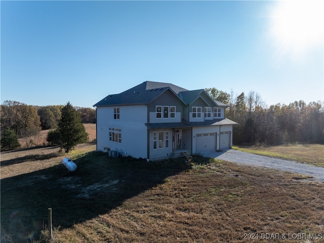 view of front of house with a front yard and a garage