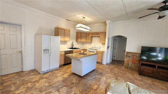 kitchen featuring a paneled ceiling, white appliances, sink, hanging light fixtures, and a kitchen island