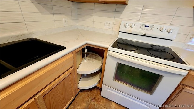 kitchen featuring backsplash, sink, and white electric stove