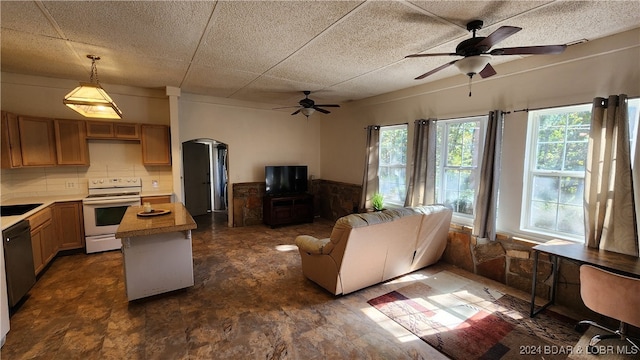 living room featuring ceiling fan and sink