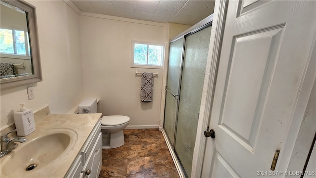 bathroom with vanity, toilet, walk in shower, and crown molding