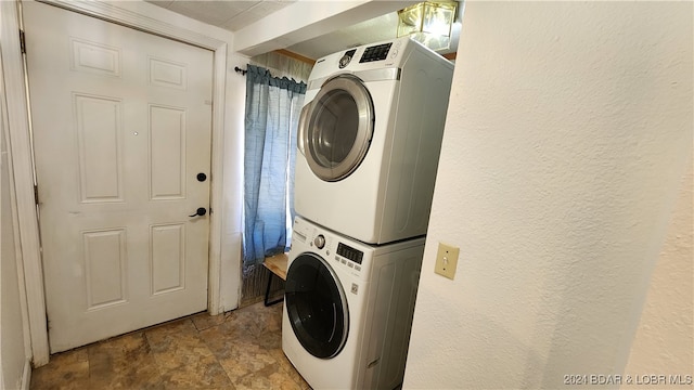 laundry room featuring stacked washer and dryer