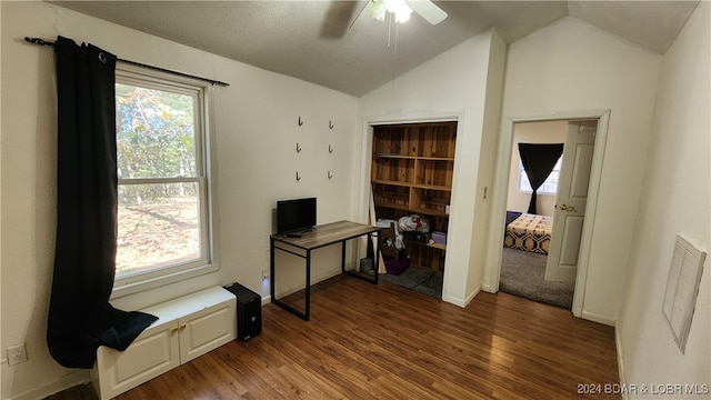 interior space with a textured ceiling, ceiling fan, wood-type flooring, and lofted ceiling