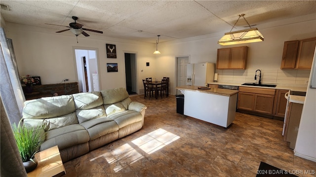 living room with ceiling fan and sink