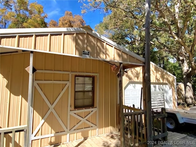 view of property exterior with an outdoor structure