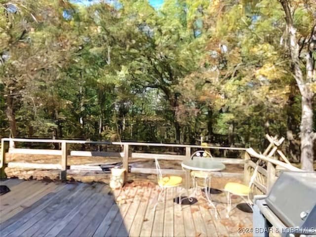 wooden terrace featuring area for grilling