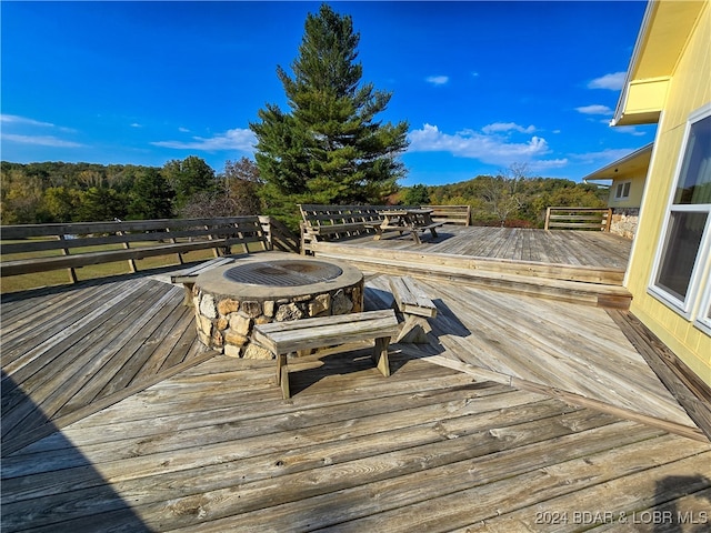 wooden deck featuring an outdoor fire pit