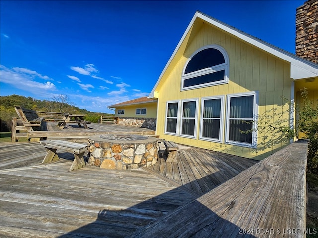 rear view of property featuring a deck