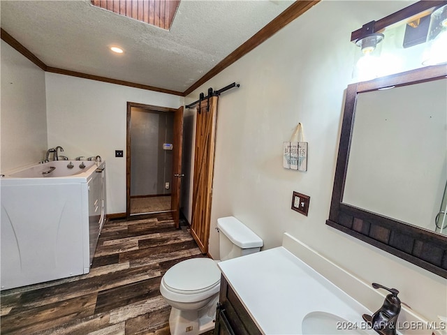 bathroom with toilet, wood-type flooring, crown molding, vanity, and a textured ceiling