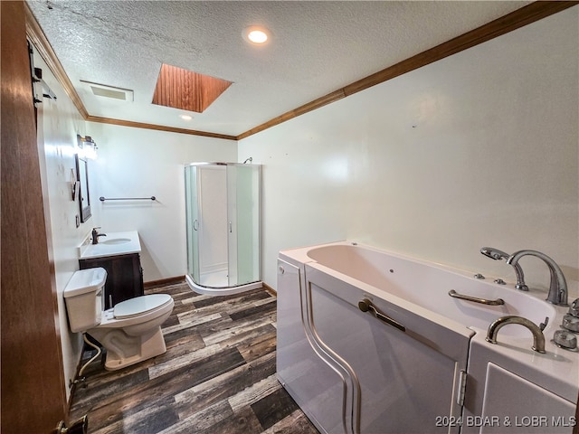 full bathroom featuring toilet, wood-type flooring, independent shower and bath, vanity, and a textured ceiling