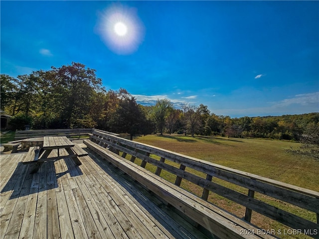 wooden deck featuring a yard