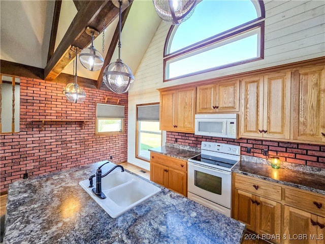 kitchen featuring white appliances, brick wall, sink, hanging light fixtures, and high vaulted ceiling