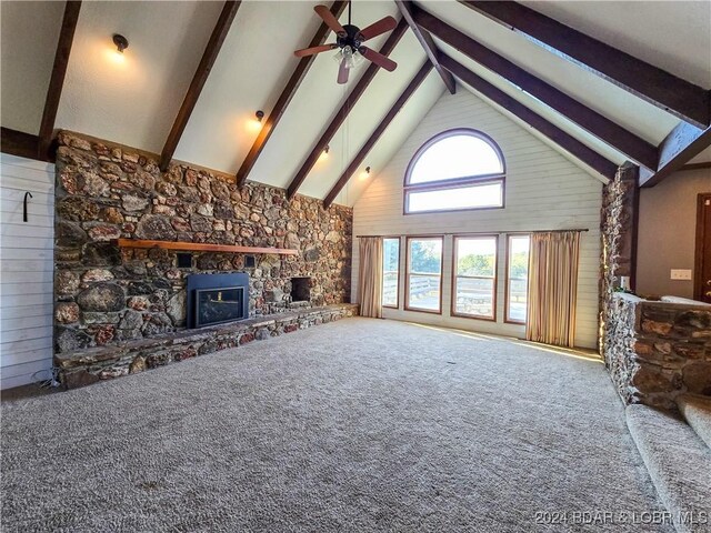 unfurnished living room featuring a fireplace, high vaulted ceiling, ceiling fan, and carpet floors