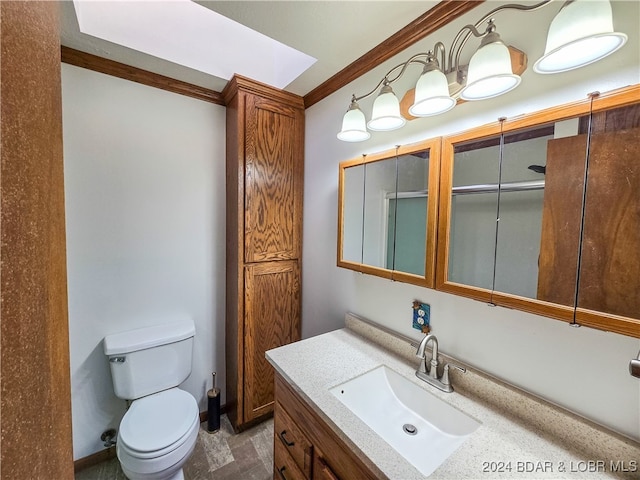 bathroom featuring ornamental molding, vanity, and toilet