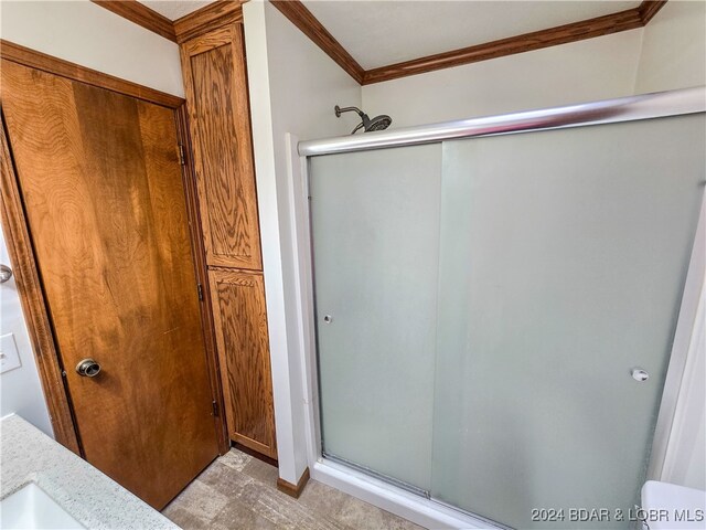 bathroom featuring walk in shower and crown molding