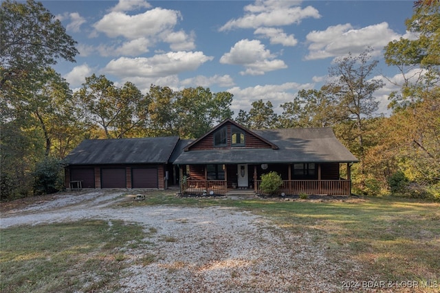 cabin featuring a garage and a porch